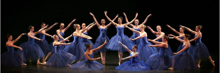 Helen Laxton dancers on stage in blue dresses