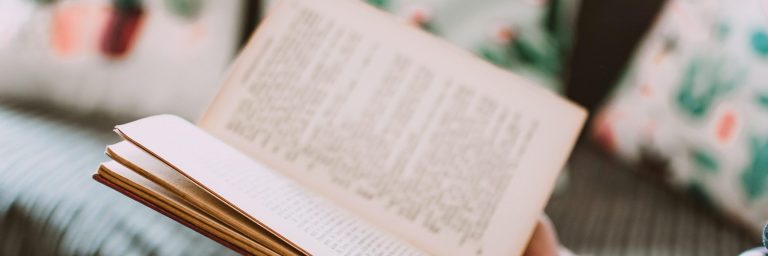 Close up on hands holding an open book